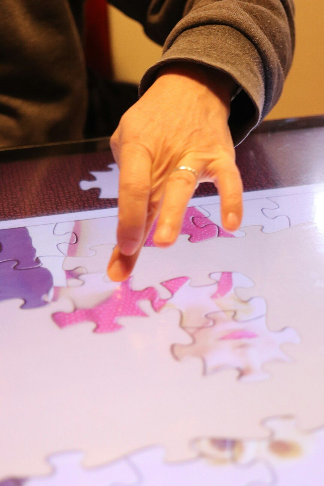 senior solving jigsaw puzzle
