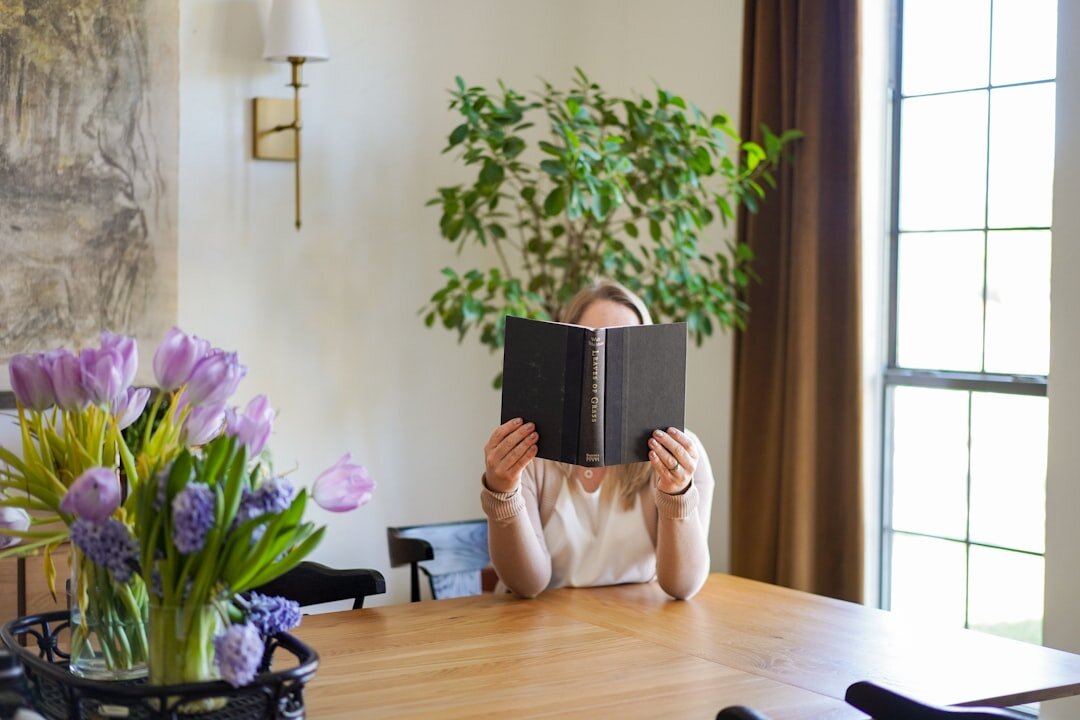 senior reading book at home